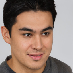 Joyful latino young-adult male with short  brown hair and brown eyes