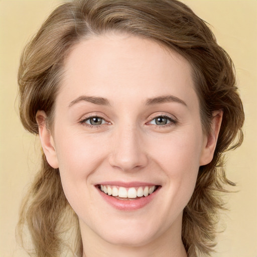 Joyful white young-adult female with medium  brown hair and green eyes