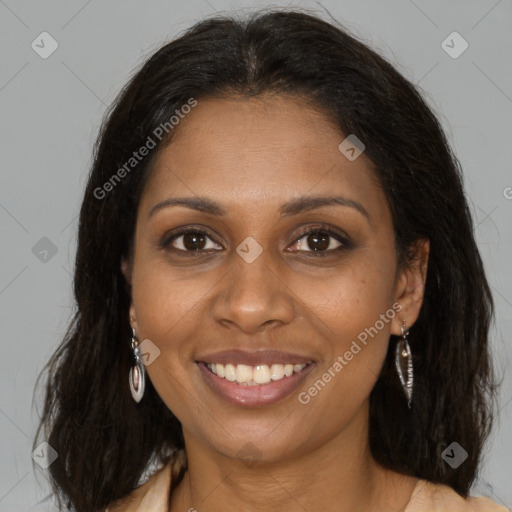 Joyful black young-adult female with long  brown hair and brown eyes