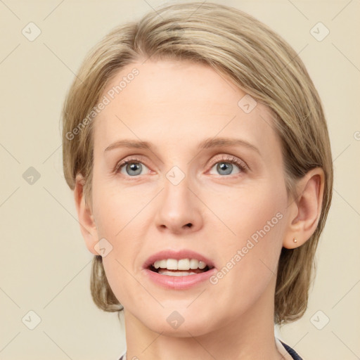 Joyful white young-adult female with medium  brown hair and blue eyes