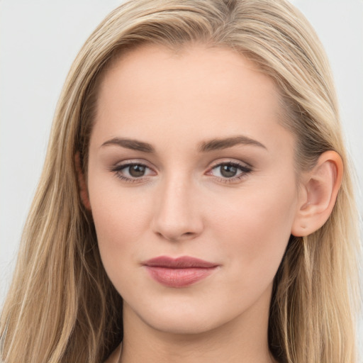 Joyful white young-adult female with long  brown hair and blue eyes