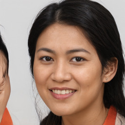 Joyful asian young-adult female with long  brown hair and brown eyes