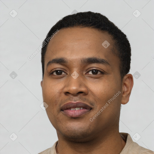 Joyful black young-adult male with short  black hair and brown eyes