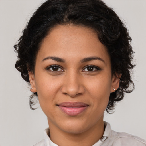 Joyful latino young-adult female with medium  brown hair and brown eyes