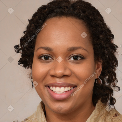 Joyful black young-adult female with long  brown hair and brown eyes