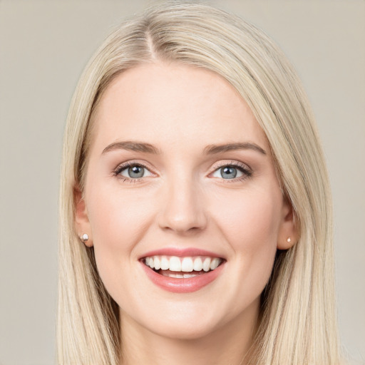 Joyful white young-adult female with long  brown hair and blue eyes