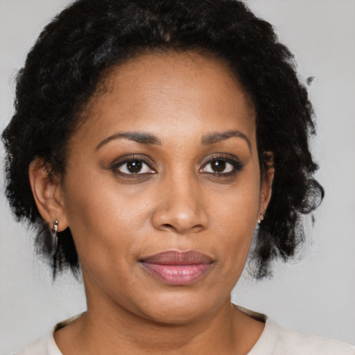 Joyful latino adult female with short  brown hair and brown eyes