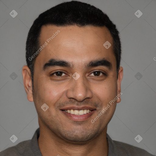 Joyful latino young-adult male with short  black hair and brown eyes