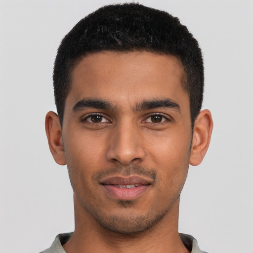 Joyful latino young-adult male with short  black hair and brown eyes