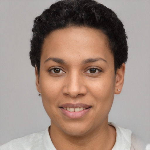 Joyful latino young-adult female with short  black hair and brown eyes
