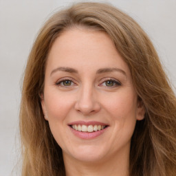 Joyful white young-adult female with long  brown hair and green eyes