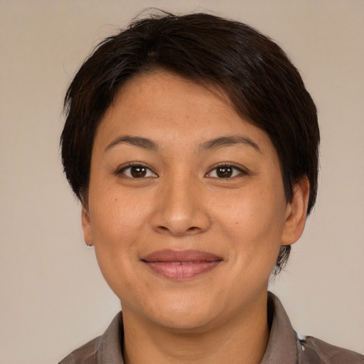 Joyful asian young-adult female with short  brown hair and brown eyes