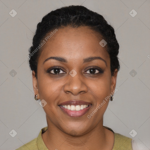 Joyful black young-adult female with short  black hair and brown eyes