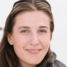 Joyful white young-adult female with long  brown hair and blue eyes