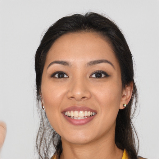 Joyful asian young-adult female with long  brown hair and brown eyes