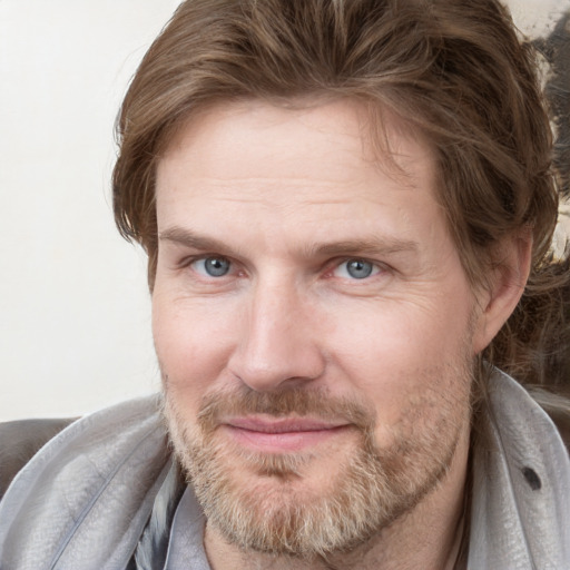 Joyful white adult male with short  brown hair and grey eyes