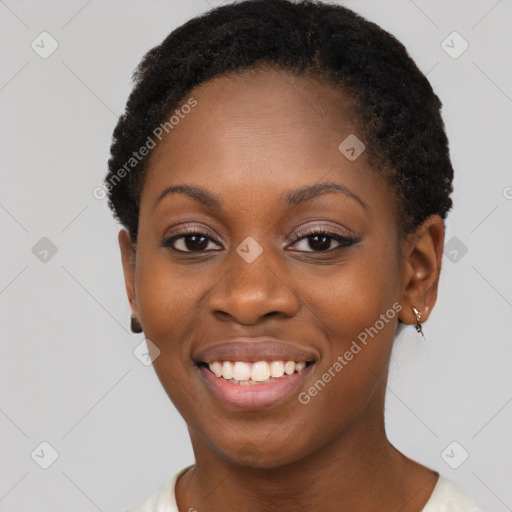 Joyful black young-adult female with short  brown hair and brown eyes