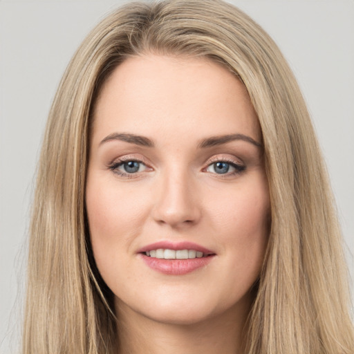 Joyful white young-adult female with long  brown hair and green eyes