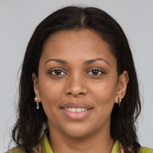 Joyful black young-adult female with medium  brown hair and brown eyes