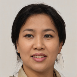 Joyful asian young-adult female with medium  brown hair and brown eyes