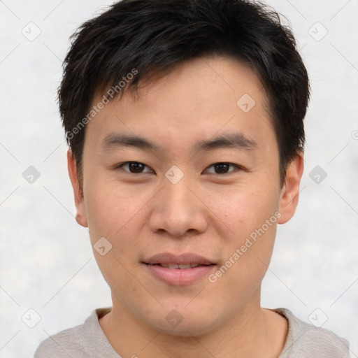 Joyful asian young-adult male with short  brown hair and brown eyes