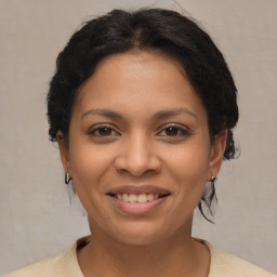 Joyful latino young-adult female with medium  brown hair and brown eyes