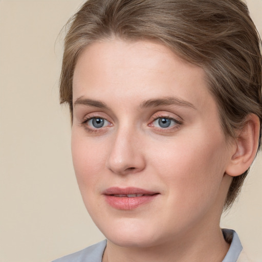 Joyful white young-adult female with medium  brown hair and blue eyes