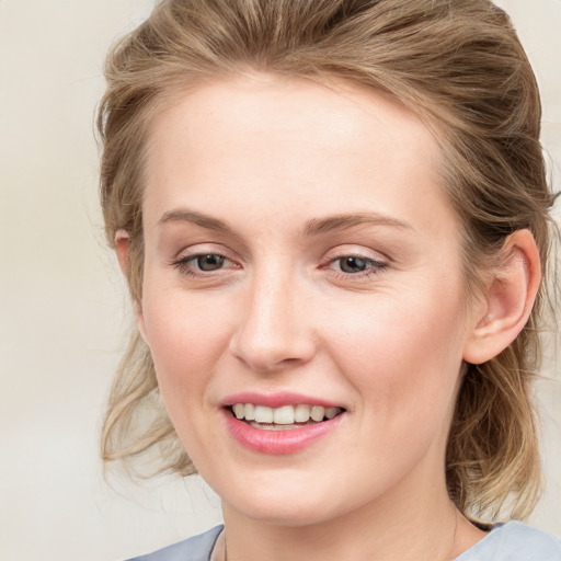 Joyful white young-adult female with medium  brown hair and blue eyes