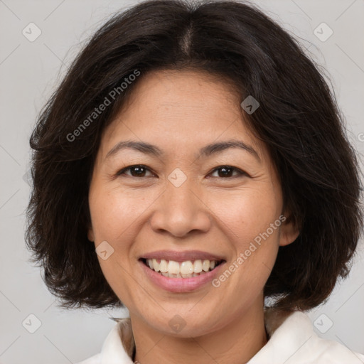 Joyful white adult female with medium  brown hair and brown eyes