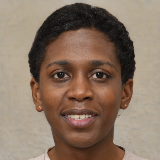 Joyful black young-adult female with short  brown hair and brown eyes