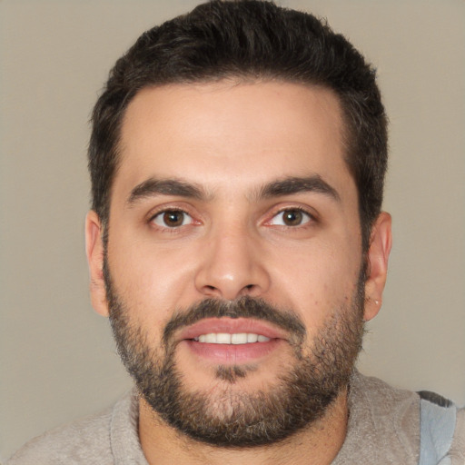 Joyful white young-adult male with short  black hair and brown eyes