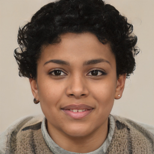Joyful black child female with short  brown hair and brown eyes