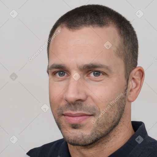 Joyful white adult male with short  black hair and brown eyes