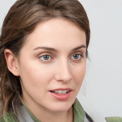 Joyful white young-adult female with medium  brown hair and green eyes