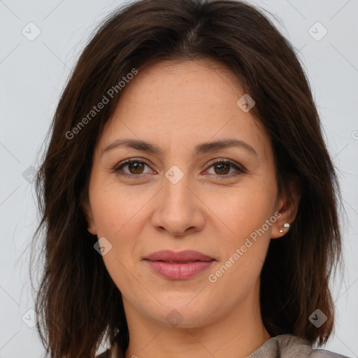 Joyful white adult female with long  brown hair and brown eyes