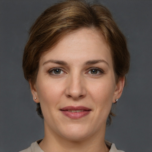 Joyful white young-adult female with short  brown hair and grey eyes