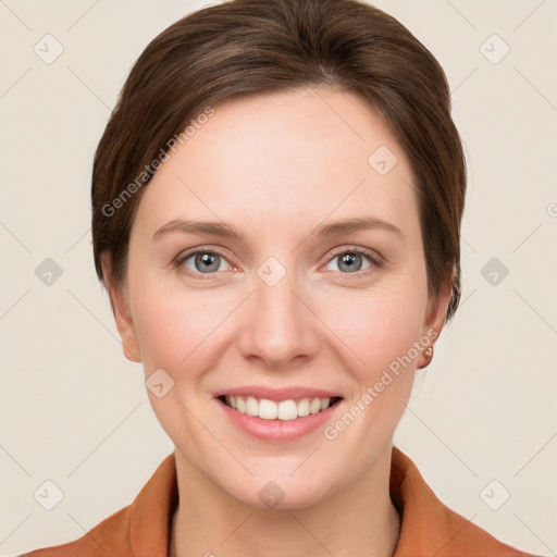 Joyful white young-adult female with short  brown hair and grey eyes