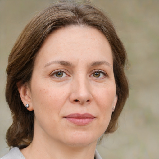 Joyful white adult female with medium  brown hair and grey eyes