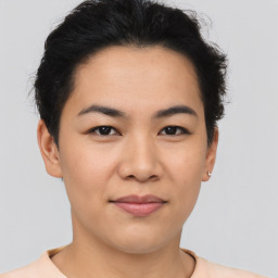 Joyful asian young-adult female with short  brown hair and brown eyes