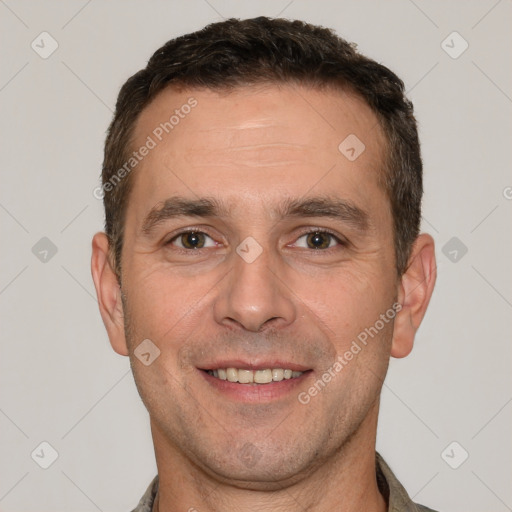 Joyful white adult male with short  brown hair and brown eyes