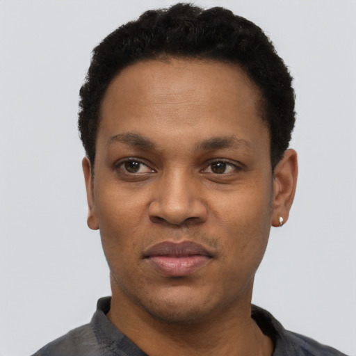 Joyful black young-adult male with short  black hair and brown eyes