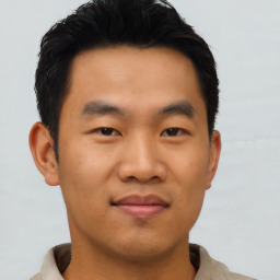 Joyful asian young-adult male with short  black hair and brown eyes