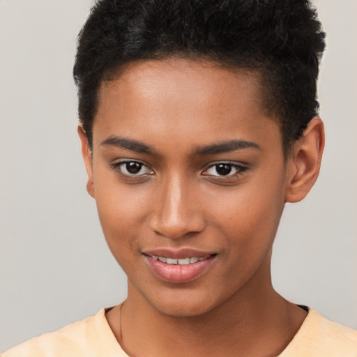 Joyful black young-adult female with short  brown hair and brown eyes