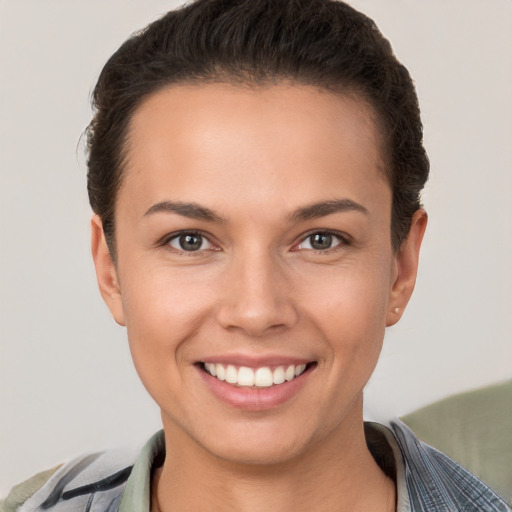 Joyful white young-adult female with short  brown hair and brown eyes