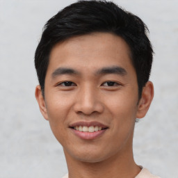 Joyful asian young-adult male with short  black hair and brown eyes