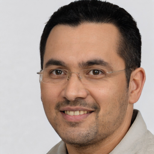 Joyful white adult male with short  black hair and brown eyes