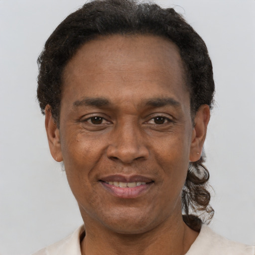Joyful latino adult male with short  brown hair and brown eyes