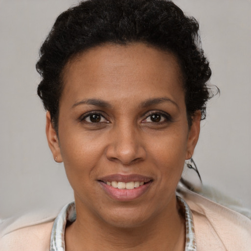 Joyful black young-adult female with short  brown hair and brown eyes