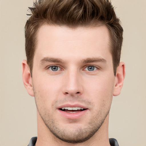 Joyful white young-adult male with short  brown hair and grey eyes