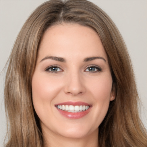 Joyful white young-adult female with long  brown hair and brown eyes